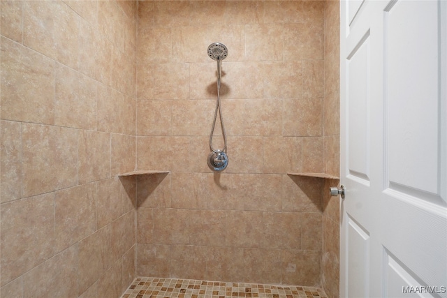 bathroom with a tile shower