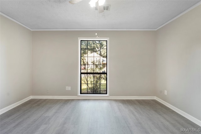 spare room with crown molding, a textured ceiling, hardwood / wood-style flooring, and ceiling fan