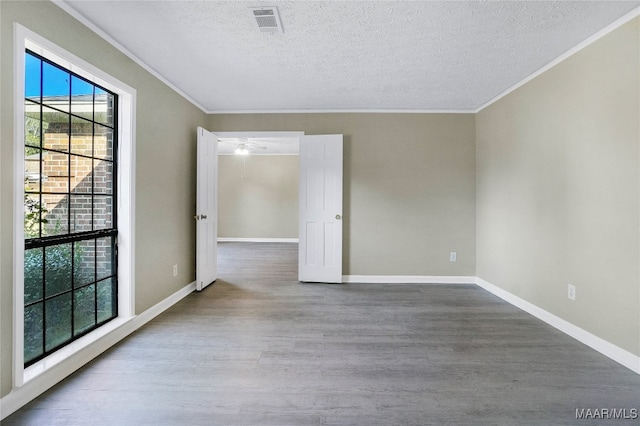 unfurnished room with wood-type flooring, crown molding, and a textured ceiling