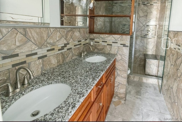 bathroom with vanity, tasteful backsplash, a shower with shower door, and tile patterned floors