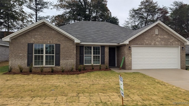 view of front of home with a front yard and a garage