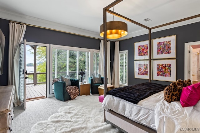 carpeted bedroom featuring access to exterior, visible vents, and crown molding