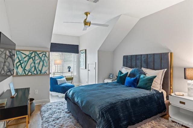 bedroom with visible vents, ceiling fan, vaulted ceiling, wood finished floors, and baseboards