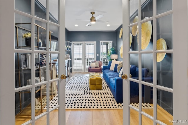 living area featuring french doors, crown molding, recessed lighting, a ceiling fan, and wood finished floors