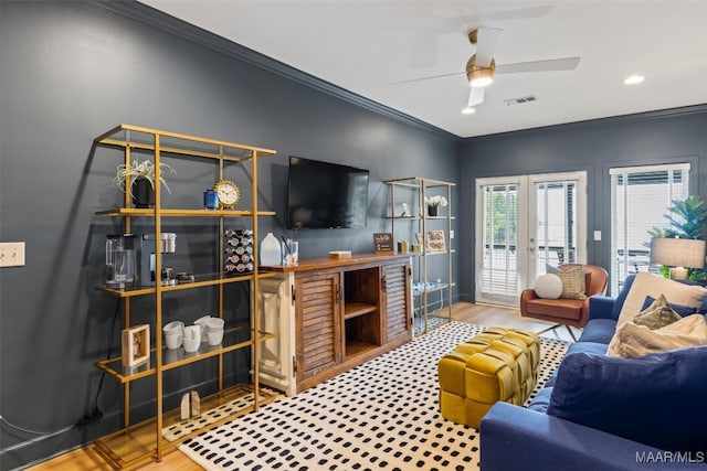 living area with ceiling fan, french doors, ornamental molding, and visible vents