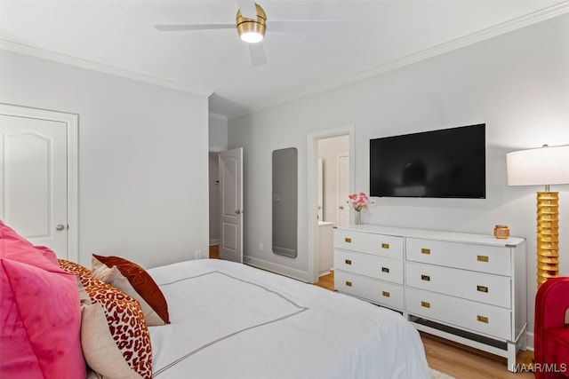 bedroom with ornamental molding, baseboards, light wood finished floors, and a ceiling fan