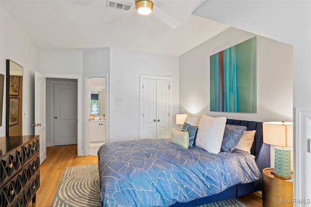 bedroom with ceiling fan, light wood-style flooring, a closet, and visible vents