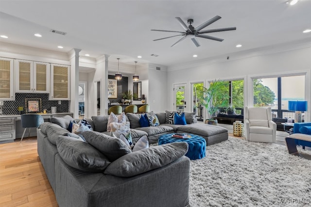 living room with ceiling fan, recessed lighting, visible vents, light wood-style floors, and ornamental molding