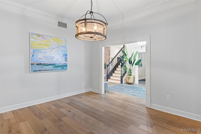 unfurnished dining area with light wood-style floors, stairway, visible vents, and a notable chandelier