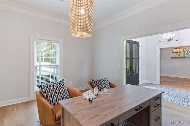 dining space with light wood-type flooring, baseboards, ornamental molding, and a notable chandelier