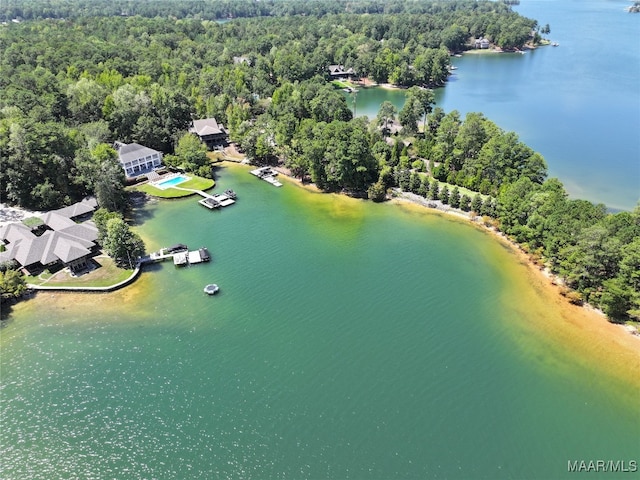 aerial view with a water view and a forest view