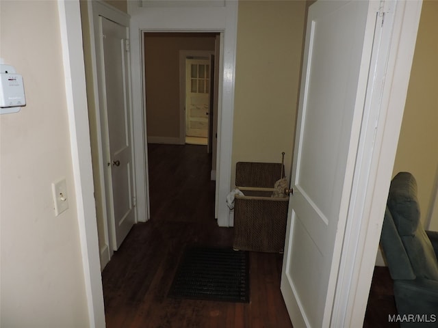 hallway with dark wood-type flooring