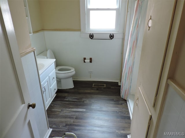 bathroom featuring a shower with curtain, toilet, hardwood / wood-style flooring, and vanity