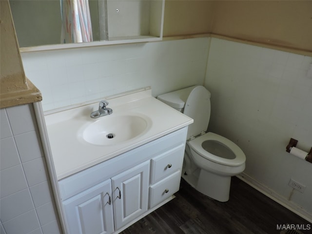 bathroom featuring hardwood / wood-style floors, toilet, and vanity