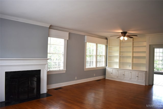 unfurnished living room featuring crown molding, wood-type flooring, built in shelves, and ceiling fan