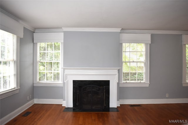 unfurnished living room with wood-type flooring, crown molding, and a healthy amount of sunlight