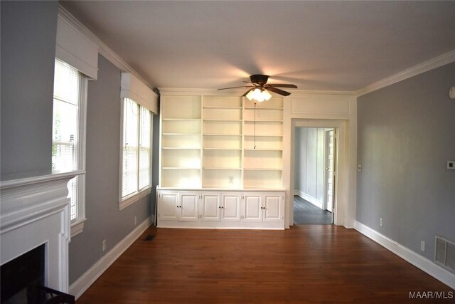 unfurnished dining area with crown molding, dark wood-type flooring, a healthy amount of sunlight, and ceiling fan