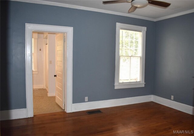 empty room with ceiling fan, a wealth of natural light, and hardwood / wood-style flooring