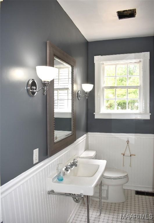 bathroom with toilet and tile patterned floors