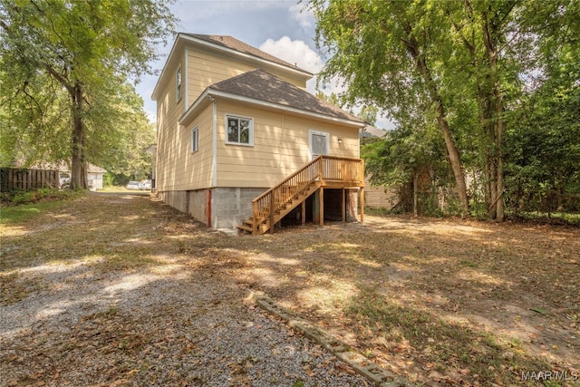 back of house featuring a deck