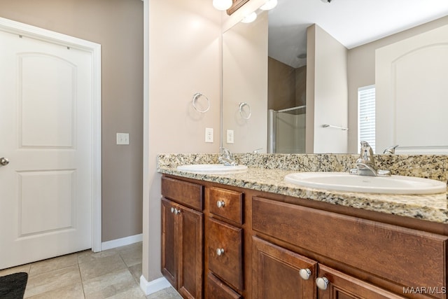 bathroom with vanity, a shower with shower door, and tile patterned floors