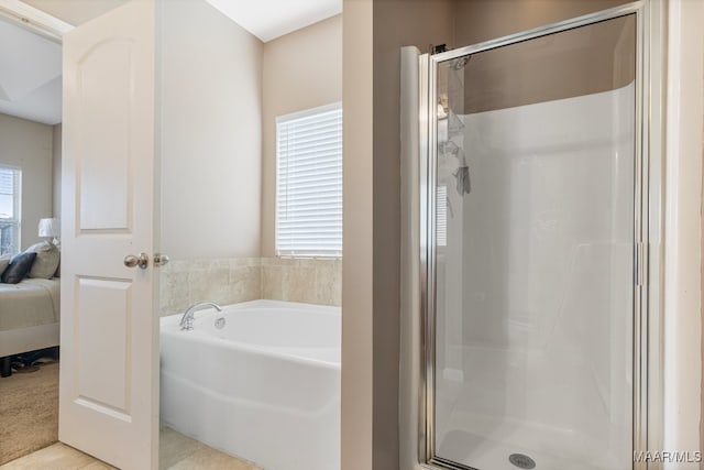 bathroom with separate shower and tub and tile patterned flooring