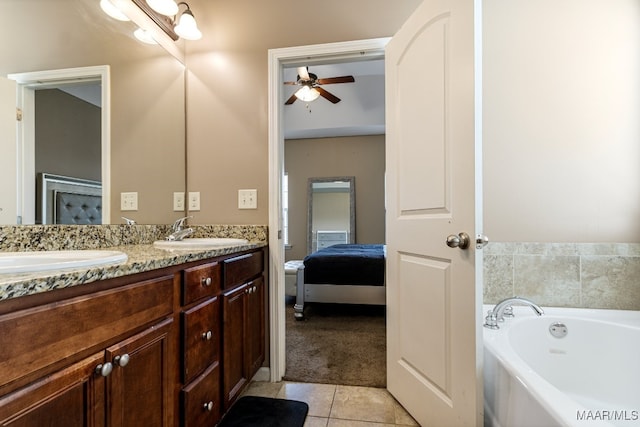 bathroom with vanity, ceiling fan, a bathing tub, and tile patterned floors