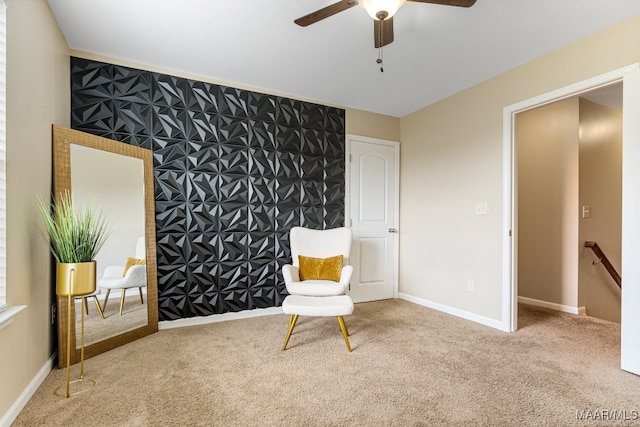 living area with light carpet and ceiling fan