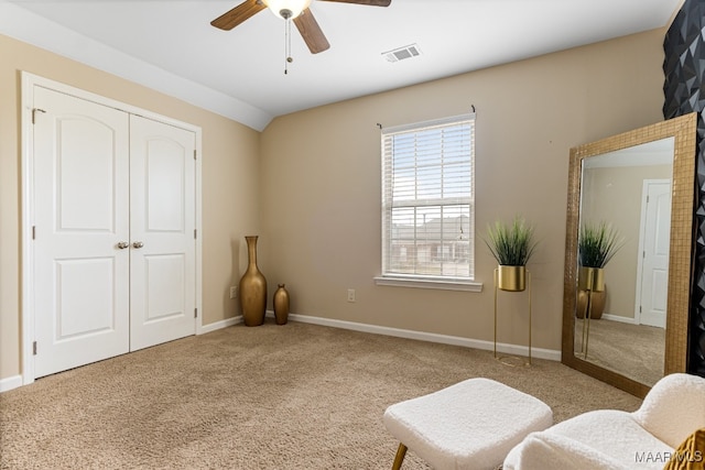 bedroom featuring lofted ceiling, light colored carpet, ceiling fan, and a closet