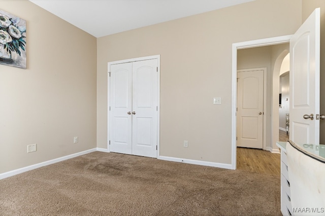 unfurnished bedroom with a closet and carpet flooring