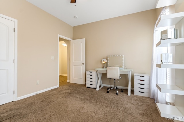 carpeted office featuring ceiling fan