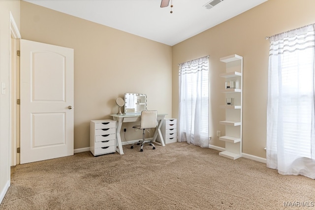 carpeted office space with ceiling fan