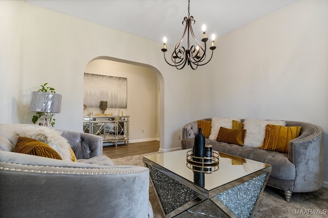 living room with wood-type flooring and a chandelier