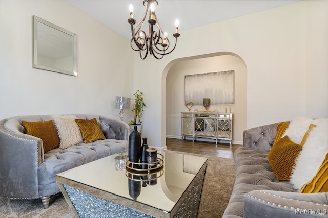 living room with wood-type flooring and a notable chandelier