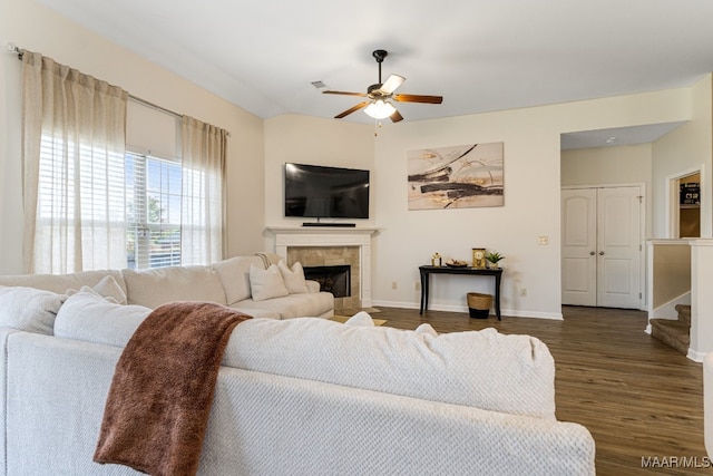 living room featuring a fireplace, hardwood / wood-style floors, and ceiling fan