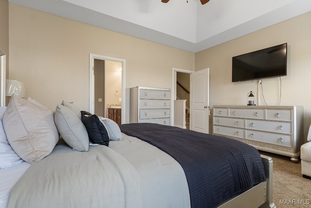 carpeted bedroom featuring ensuite bath and ceiling fan