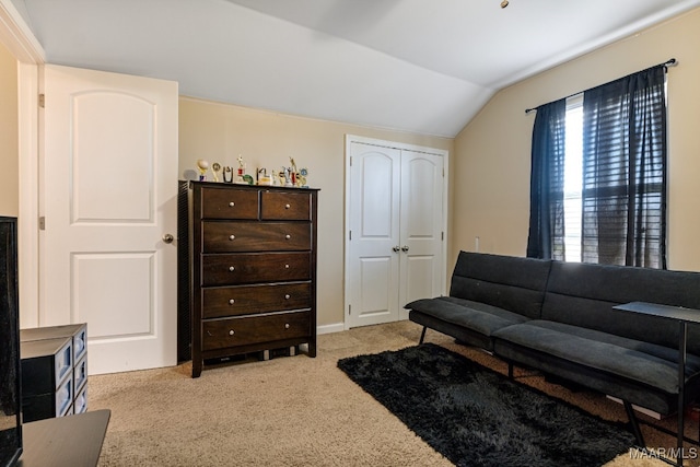 carpeted living room featuring lofted ceiling