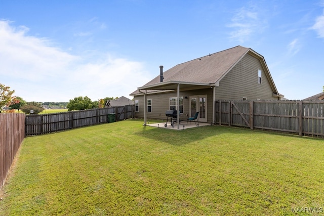 back of property with a lawn and a patio area