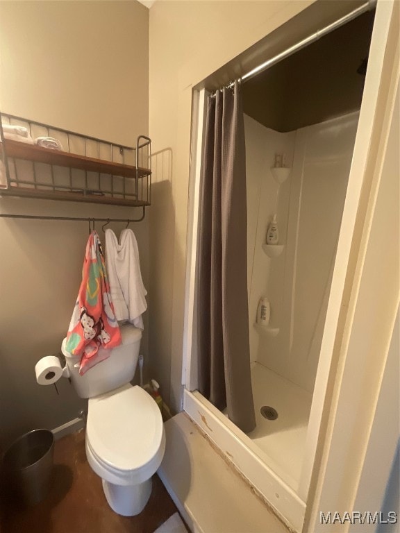 bathroom featuring walk in shower and toilet