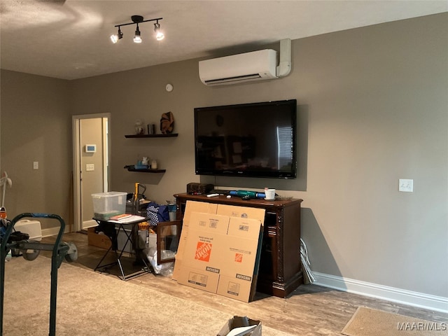 interior space featuring light wood-type flooring and a wall unit AC