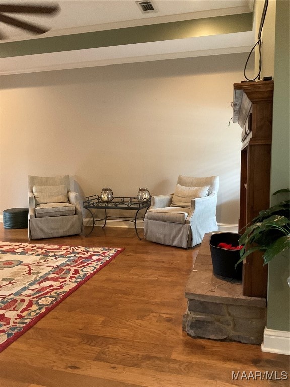 living room with ceiling fan and hardwood / wood-style floors