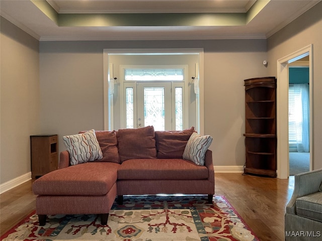 living room featuring crown molding, plenty of natural light, and hardwood / wood-style flooring