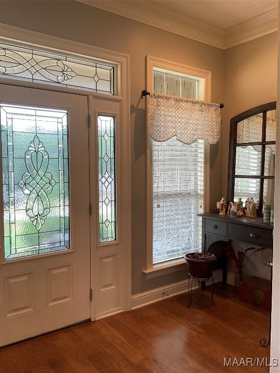 entrance foyer featuring crown molding, a wealth of natural light, and hardwood / wood-style flooring