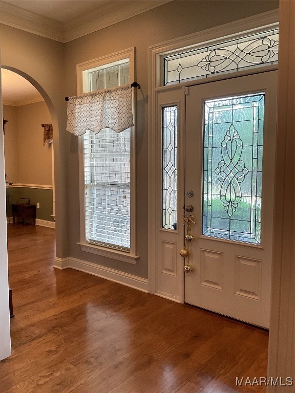 foyer with hardwood / wood-style flooring and crown molding