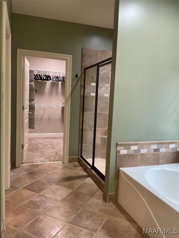 bathroom featuring independent shower and bath and tile patterned floors