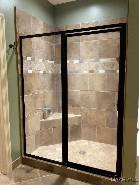 bathroom with walk in shower and tile patterned floors