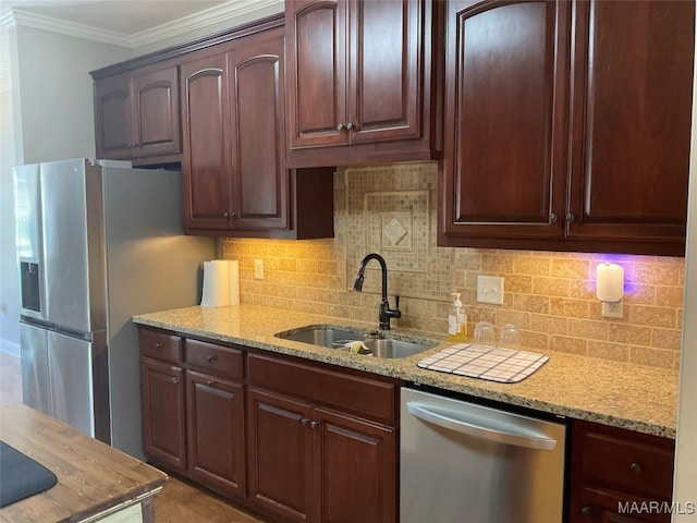 kitchen with appliances with stainless steel finishes, crown molding, decorative backsplash, and sink