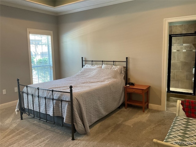 carpeted bedroom with ensuite bathroom and crown molding