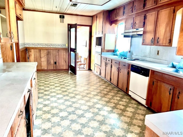 kitchen featuring white appliances and wooden walls