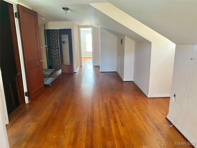 bonus room featuring vaulted ceiling and hardwood / wood-style floors